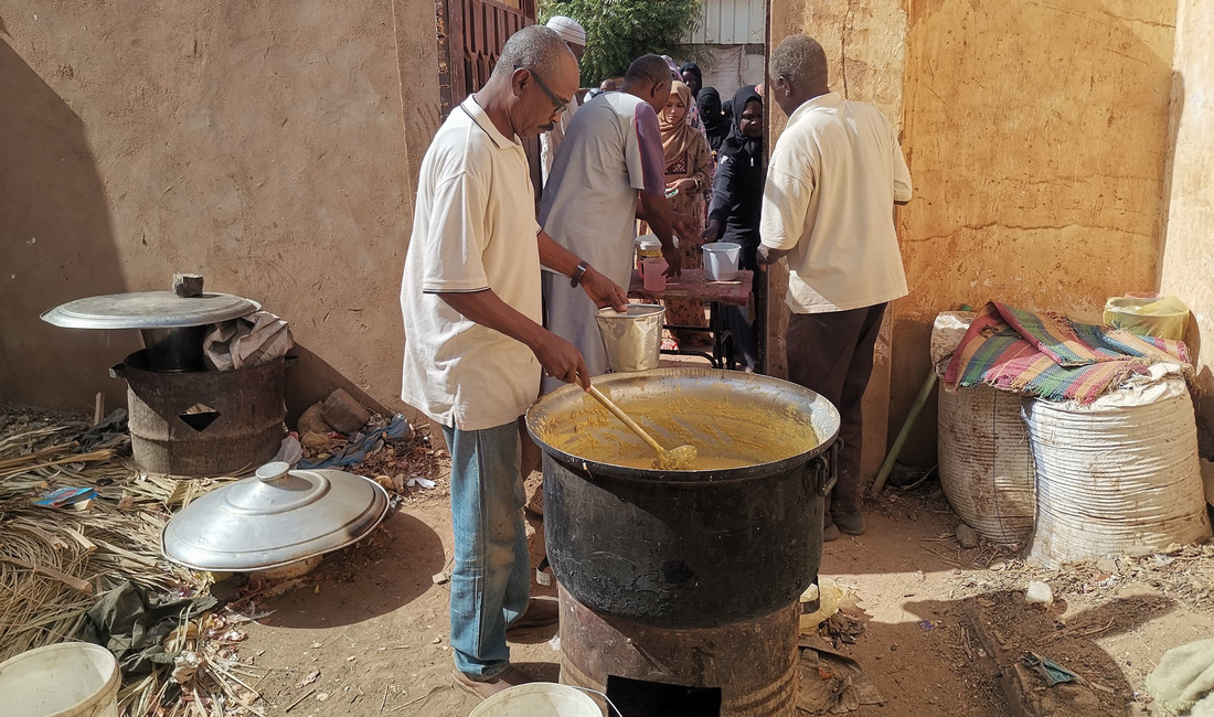 Dieses Foto zeigt einen Freiwilligen, der draußen vor einem großen Topf stehend, im Stadtteil Karari der Stadt Omdurman, nordwestlich der sudanesischen Hauptstadt Khartum, kostenloses Essen für Vertriebene zubereitet und verteilt. 