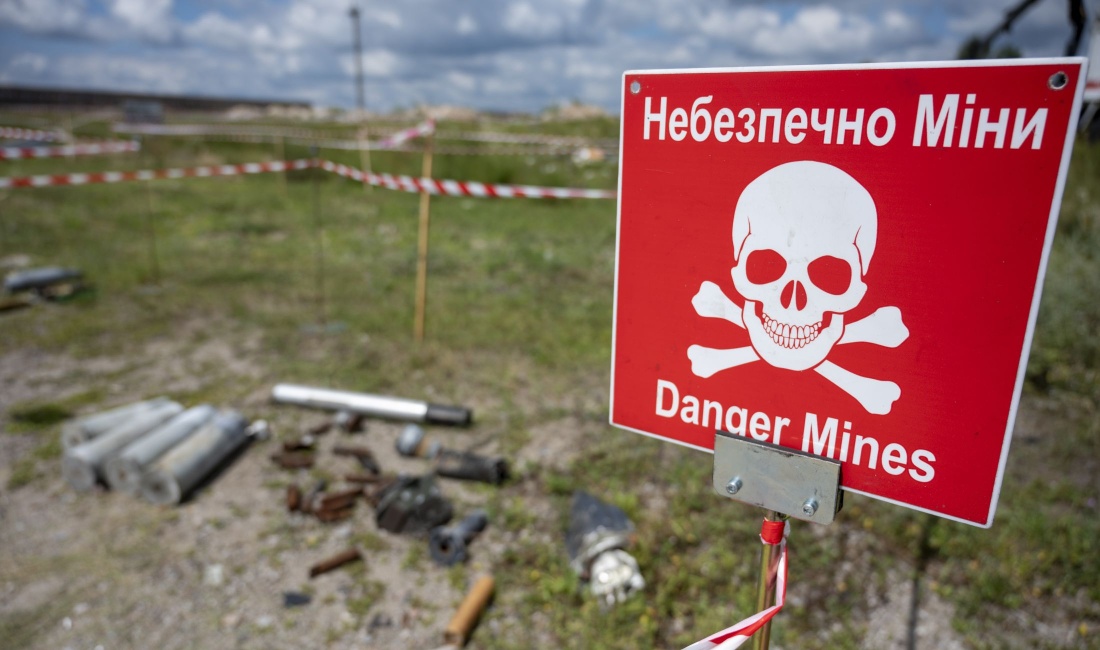 Auf dem Gelände des Antonov Flughafens in der Ukraine ist ein Übungsgelände für die Beseitigung von Minen und Kampfmitteln. Am Rand steht ein Warnschild mit der Aufschrift „Danger Mines“.